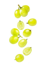 Green grapes with cut in half sliced flying in the air isolated on white background.