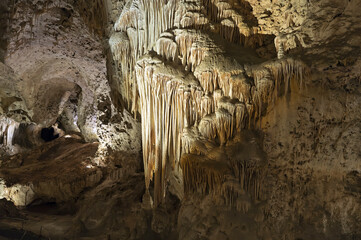 Cave flowstone hangs downward, create curtain-like sheaves along ledges, better known as...