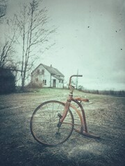 old bicycle with abandoned house 
