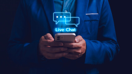 Live chat technology concept. Man hands holding a smartphone with Live Chat online communication...
