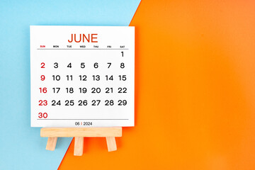 2024 June calendar page on blue and orange background.
