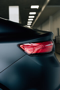 Modern rear light on new matte black automobile