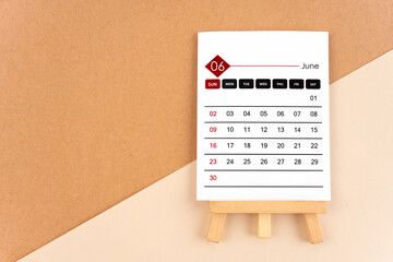 2024 June calendar page on brown background.