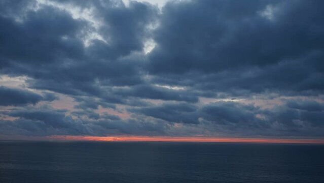 Time lapse of a sunrise panorama from a very high location. The sun rises from the sea water. Incredible sunrise