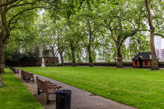 Pimlico Gardens is a small riverside park which is laid out with trees and grass, the statue of William Huskisson, seating and a drinking fountain.  Shot 20 May 2024