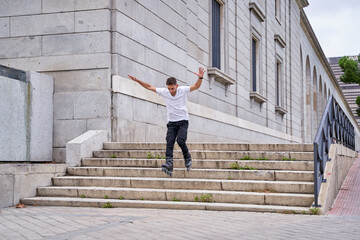 young male inline skater descending stairs without braking