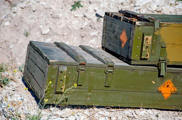 Vintage military suitcase, army box of ammunition in ground. Ammo from Second World War. Soviet...