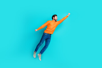 Photo of funny cheerful man wear stylish clothes raise hand fly empty space isolated on cyan color...