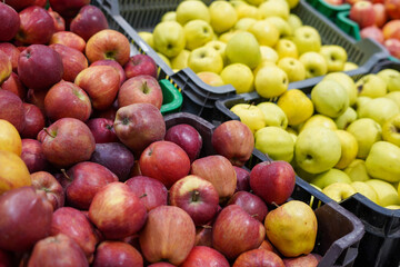 Red and yellow apples on the market counter. Apples in the cardboard boxes on the grocery shelf