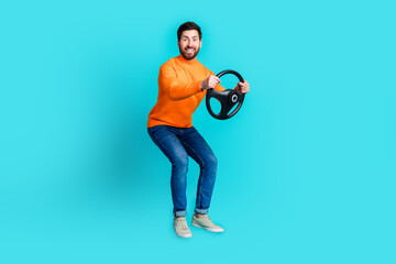 Photo of cheerful bearded man wear trendy clothes drive car isolated on cyan color background