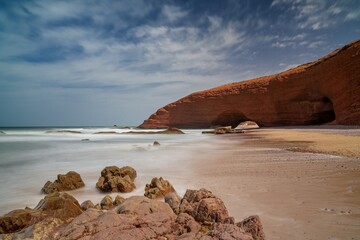 long exposure view of the beach and rock arch at Legzira on the Atlantic Coast of Morroco