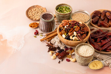Natural raw foods ingredients and nuts placed on a marble surface table in a flat layout copy space...