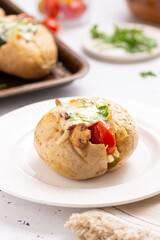 Hot Vegetarian Loaded Potato with mushrooms, cheese, tomatoes and parsley. Real Food Photo.