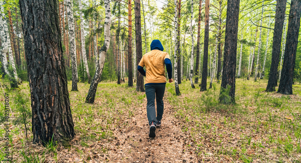 Poster person running in the forest