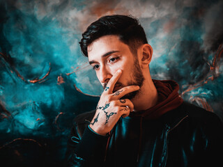 Young Man in Leather Jacket Posing Against Artistic Blue and Black Wall at Night
