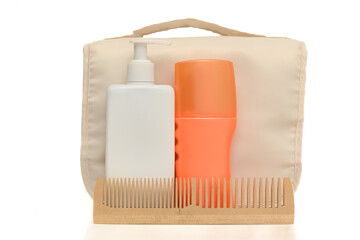 Women's cosmetics in a compact bag for travel. On a white background.