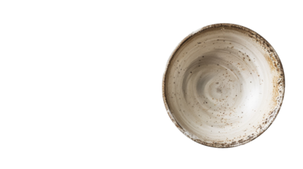A white bowl sits on top of a wooden table in a simple setting