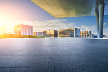 Empty square floor with modern city buildings background