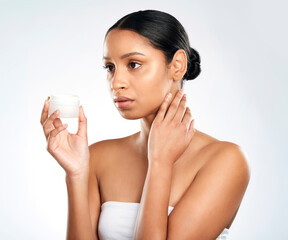 Thinking, container and woman with cream, skincare and dermatology on white studio background....