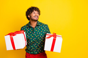 Photo of attractive elegant young man giftbox look empty space wear shirt isolated on yellow color background