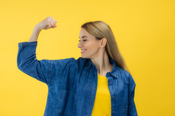 Strong powerful woman raise arm and show biceps look at muscles