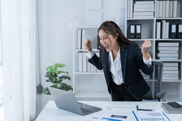 The Asian female business professional displayed a cheerful expression in her office.