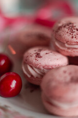pink macarons served with cherries 