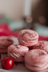 pink macarons served with cherries 