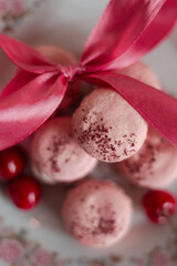 pink macarons served with cherries 