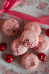 pink macarons served with cherries 