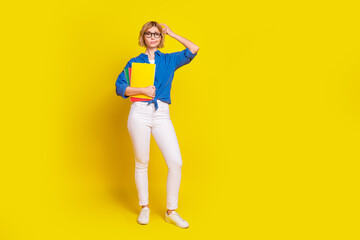 Full size photo of nice young girl scratch head think wear shirt isolated on yellow color background