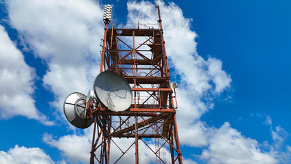 Telecommunication technology tower construction with satellite plate and antennas