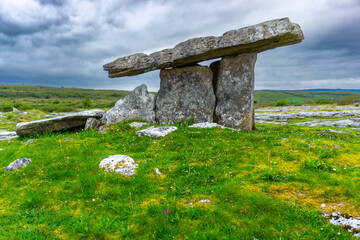 Poulnabrone dolmen in Burren geopark, Ireland, with dramatic cloud sky