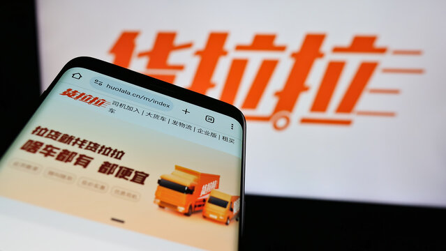 Stuttgart, Germany - 05-17-2024: Mobile phone with website of Chinese logistics platform company Huolala in front of business logo. Focus on top-left of phone display.