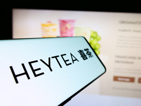 Stuttgart, Germany - 05-17-2024: Smartphone with logo of Chinese drink chain company Hey Tea (HeyTea) in front of business website. Focus on center-left of phone display.