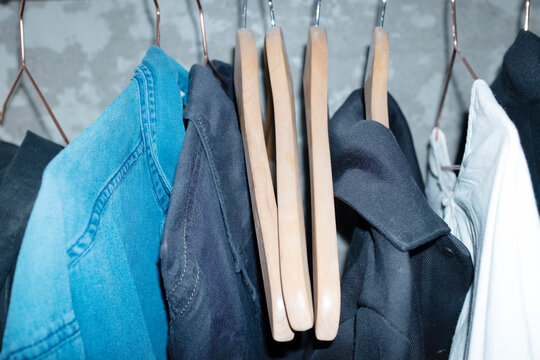 Clothes with hangers on a cloth rack with hard direct flashlight