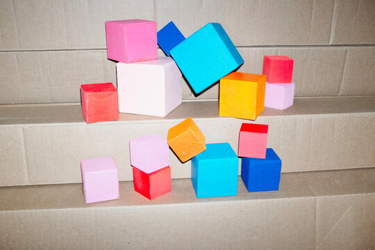 Colourful geometric cubes on a cardboard with hard direct flashlight