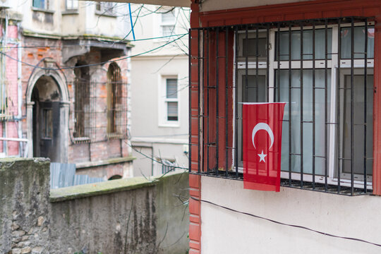 A Turkish flag hanging from a window.