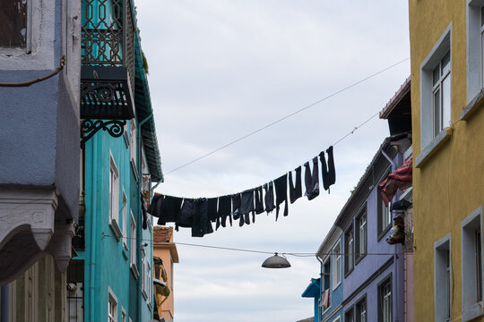 Looking up at clothes drying on a line between historic building
