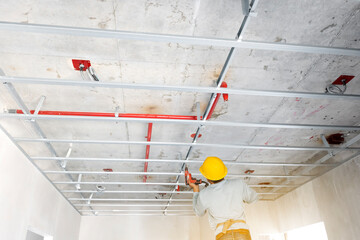 install ceiling house in construction site by technician. © noppadon
