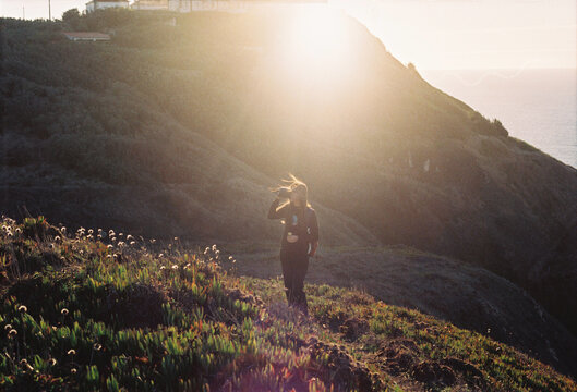 Woman filming at Sunset With Golden Hour Lighting