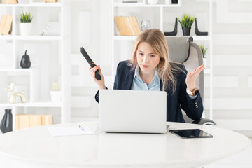 Nervous business woman threatening with gun in the office. Stressful work and business crisis...