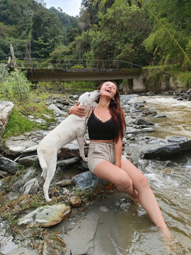 Woman and dog in a river