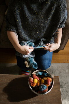 woman prepping colorful roving fiber for spinning