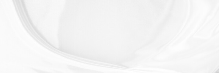 White gray satin texture that is white silver fabric silk panorama background with beautiful soft blur pattern natural.