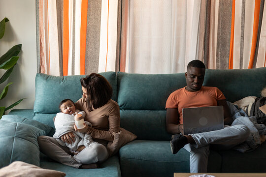 
A FAMILY IN THE LIVING ROOM OF THEIR HOUSE
