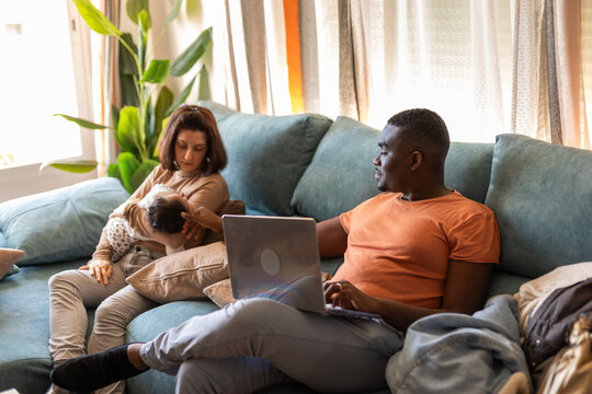 
A FAMILY IN THE LIVING ROOM OF THEIR HOUSE