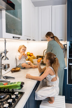 A woman and her children in the kitchen 