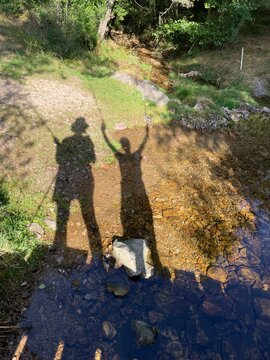 UGC of  shadow of two hikers, mom and and son