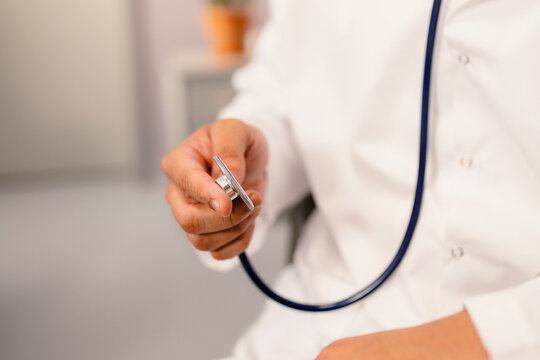 A doctor's hand with a stethoscope